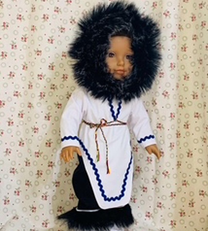 A doll dressed in a white parka with a dark fur ruff and beaded trim.