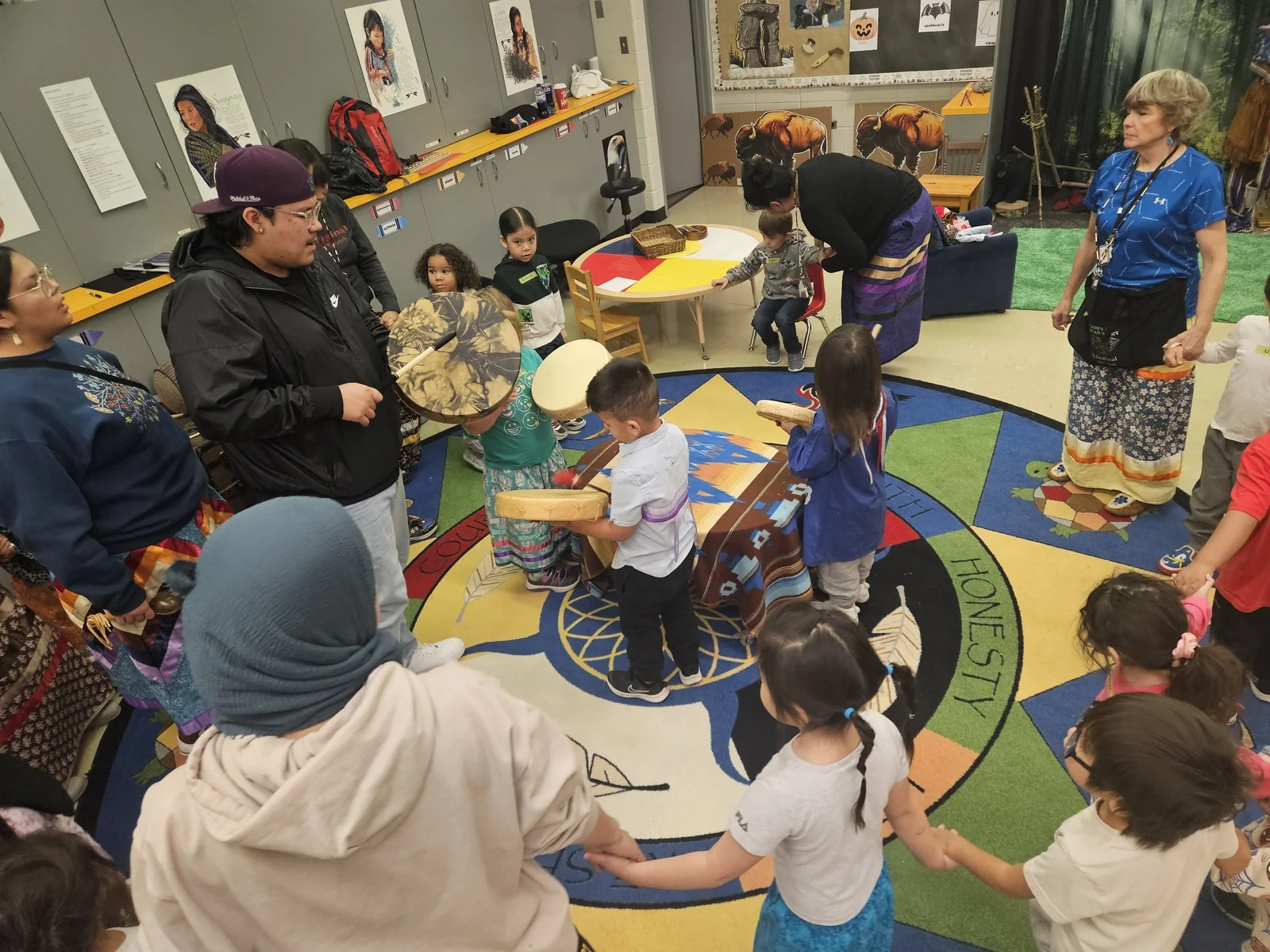 A wide view of the drumming circle filling the room.